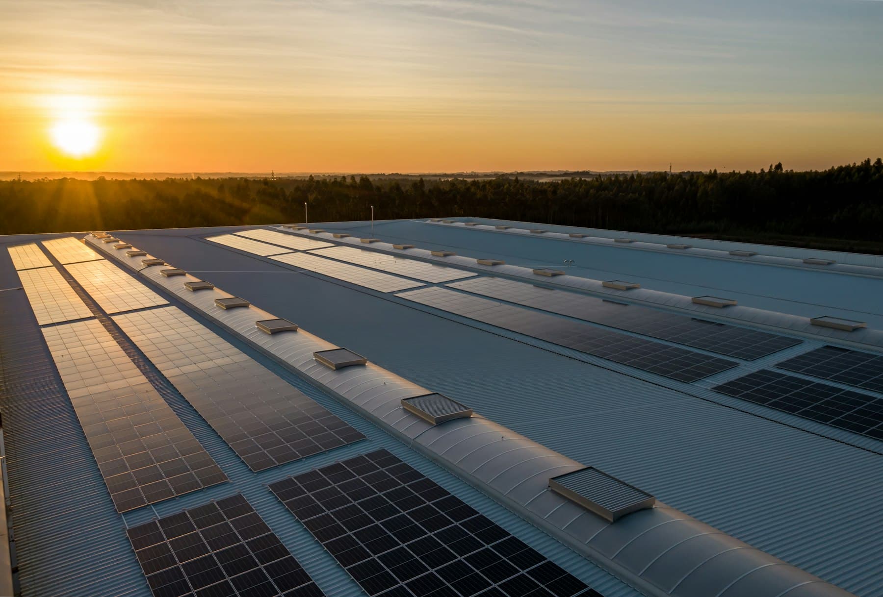 Commercial rooftop solar array across an industrial warehouse