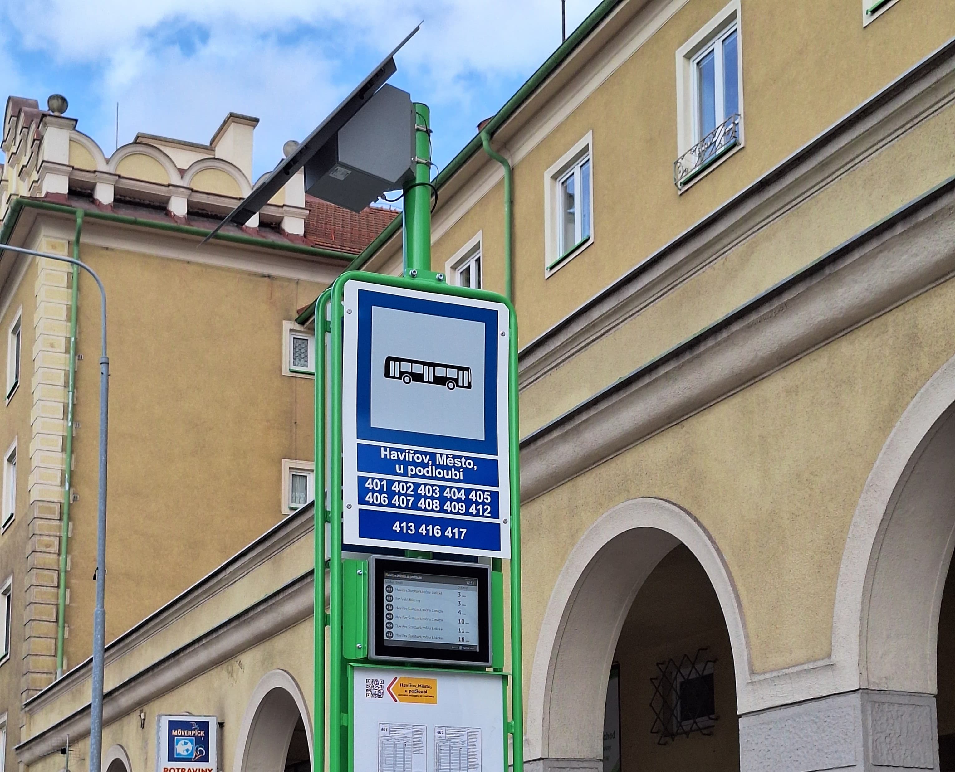 Solar-powered outdoor passenger information display at a transit stop