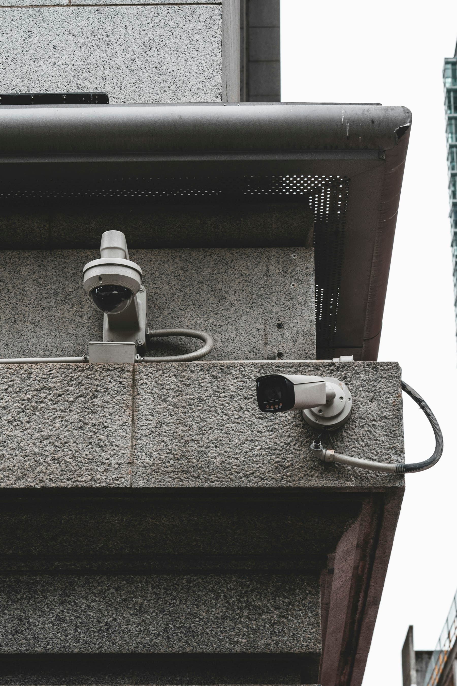 Dome and bullet cameras mounted on a commercial building facade