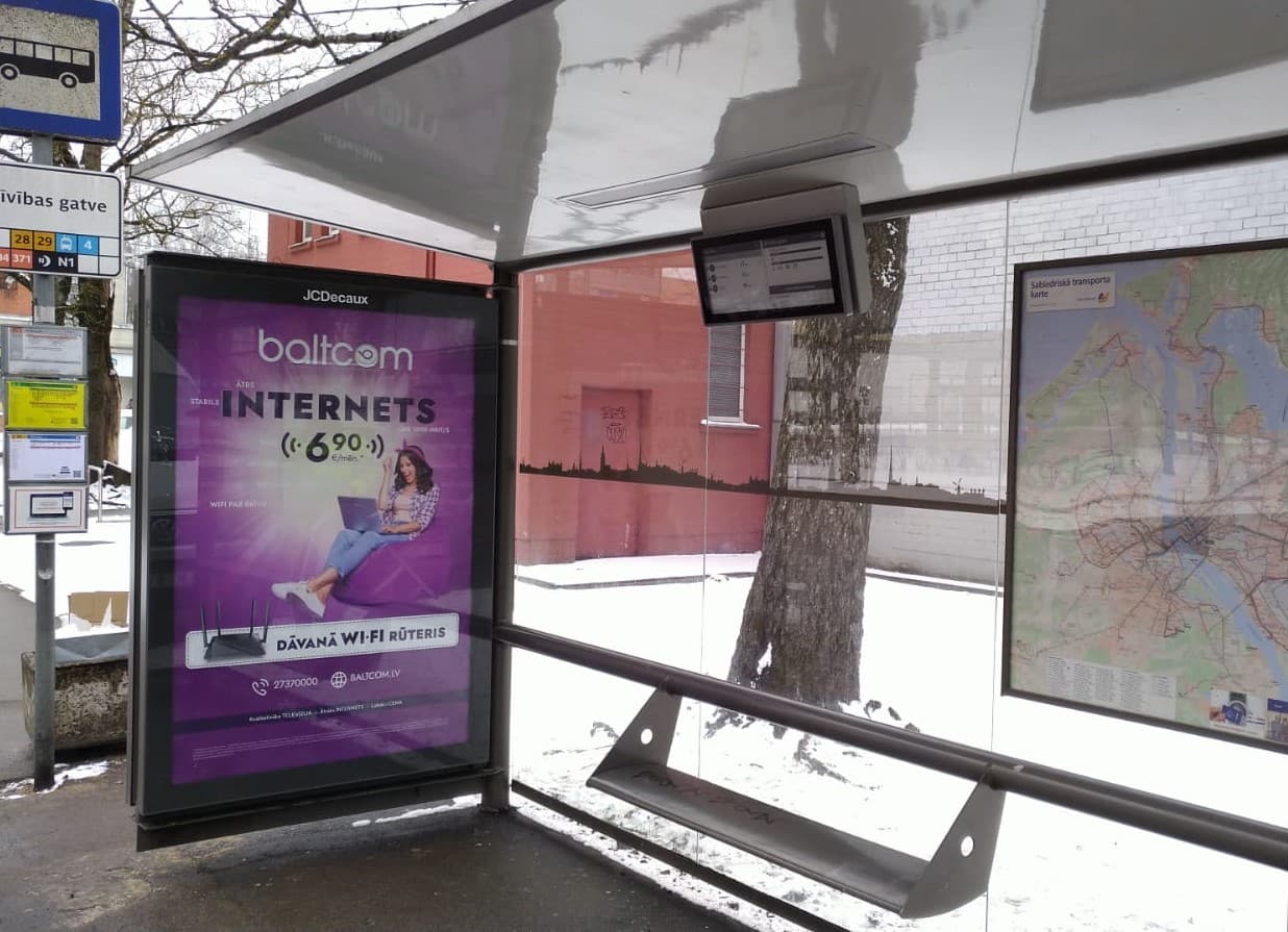 Digital passenger information display integrated into a transit shelter
